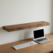Scale reference photo for Entrepot La Grange inc Solid Wood Shelf: length visualized against a standard office keyboard and a 13-inch laptop, emphasizing 48-inch length.