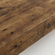 Extreme close-up of a rustic wood beam, highlighting deep grain, knots, and dark patina.