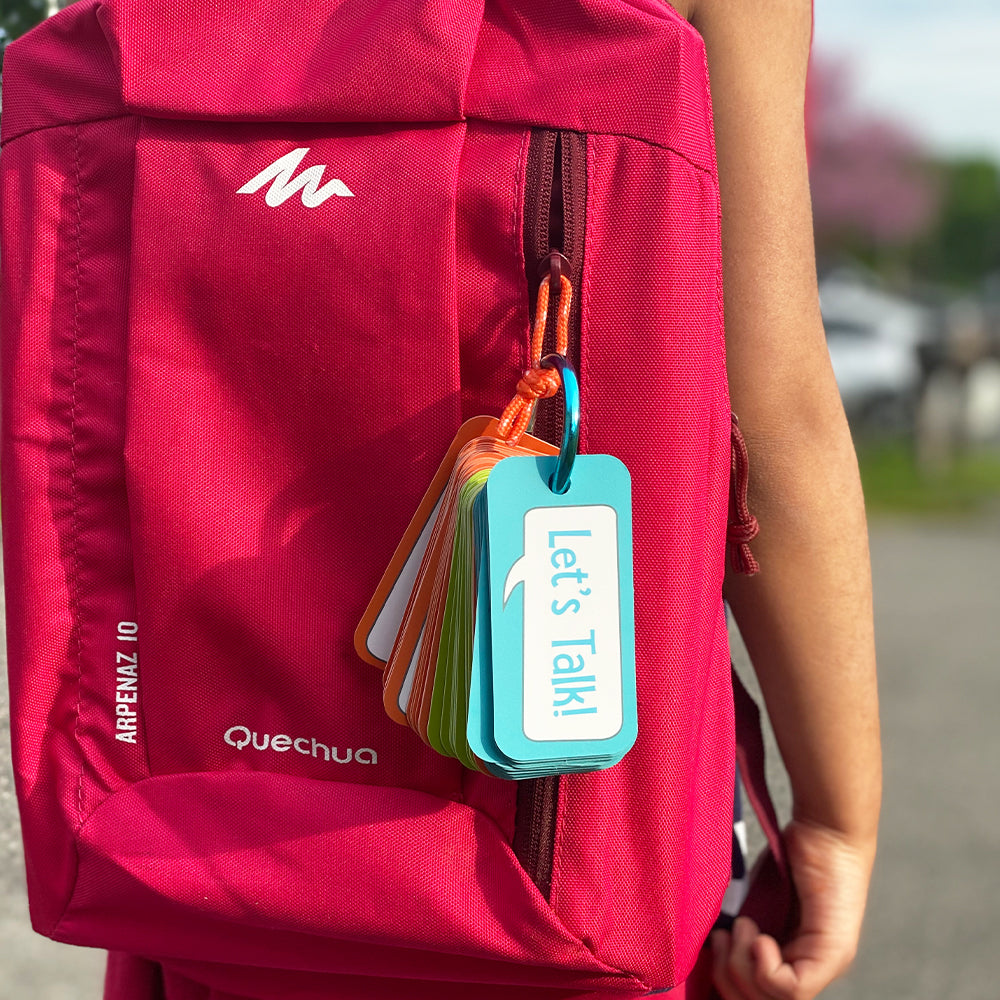 Let's Chat conversation cards clipped to the strap of a child's backpack