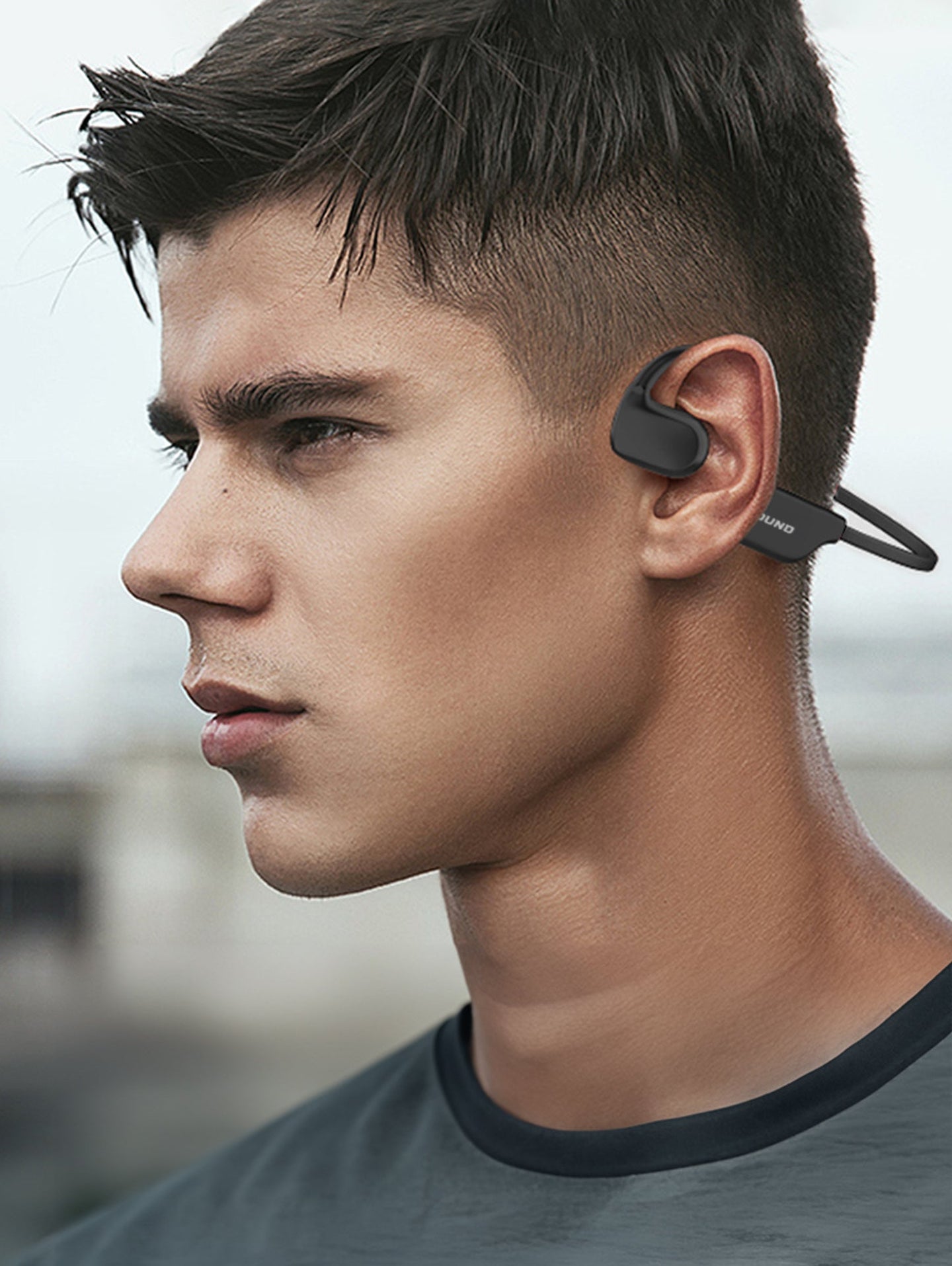 Man wearing OPN Sound Aperto open-ear headphones