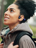 Woman outdoors wearing OPN Sound Mezzo+ open-ear headphones