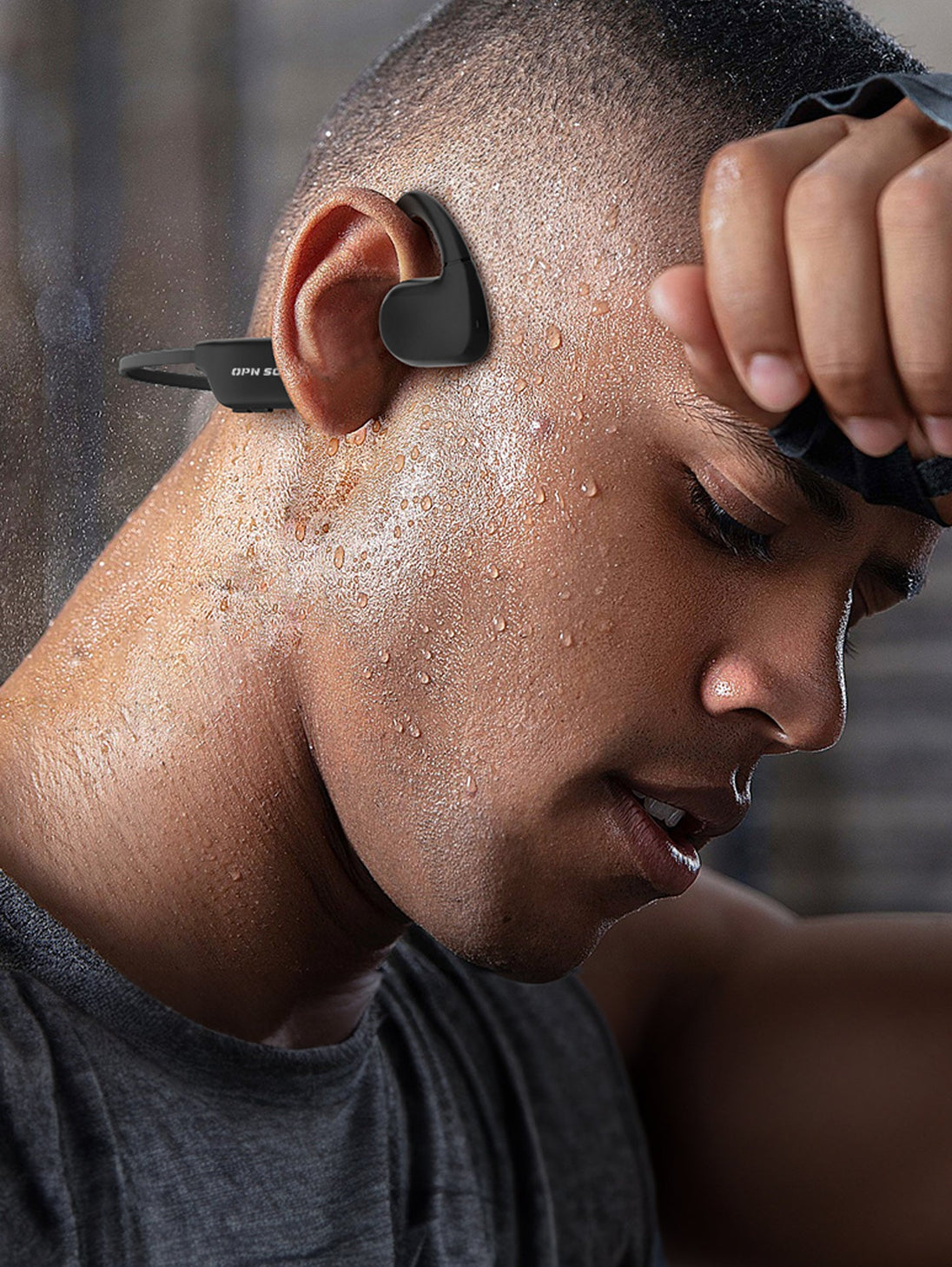 Athlete wearing OPN Sound Aperto open-ear headphones after a workout