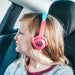 Girl wearing Wicked Audio Tricky Tike Candy Pink headphones in a car