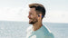 Man by the water wearing OPN Sound Mezzo+ headphones