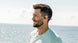 Man by the water wearing OPN Sound Mezzo+ headphones
