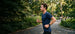 Runner in a park wearing OPN Sound Aria Pro headphones