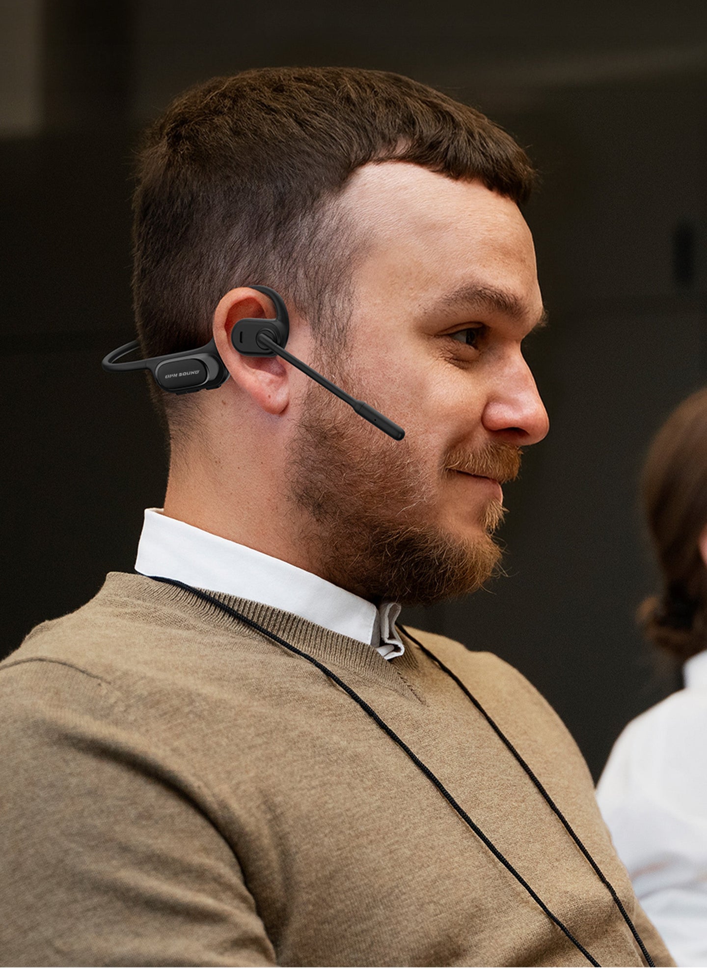 Man wearing OPN Sound Chat Pro headset in an office