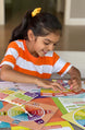 Girl playing with the Learning Emotions board and cards