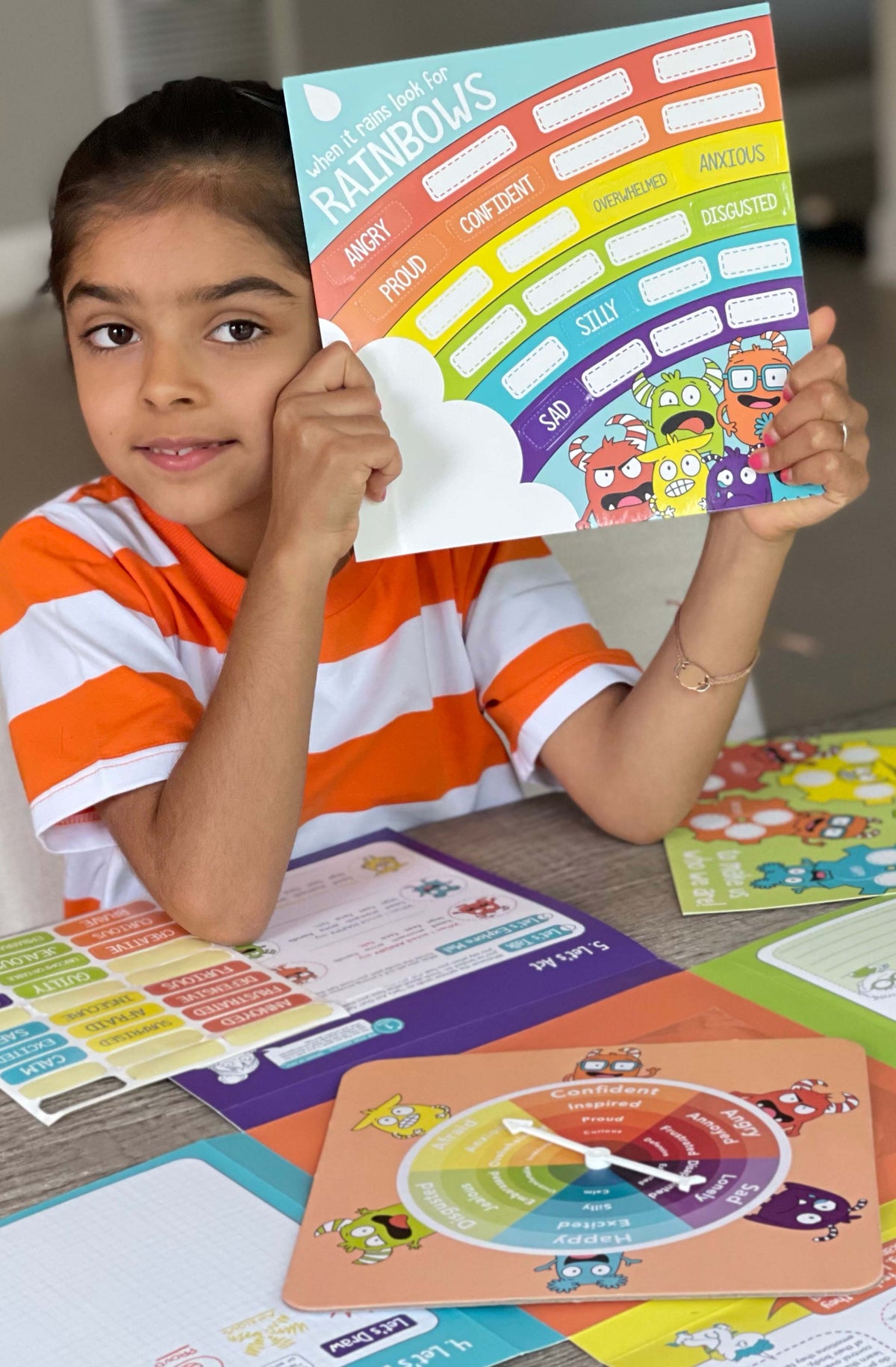 Girl holding up the Learning Emotions chart