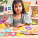 Young girl at a table using the Emotions 123's dry-erase cards