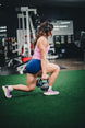 Woman training with a kettlebell while wearing Wicked Audio Hum 500x headphones