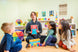Teacher showing Jumbo ABC Emotion Cards to a group of children