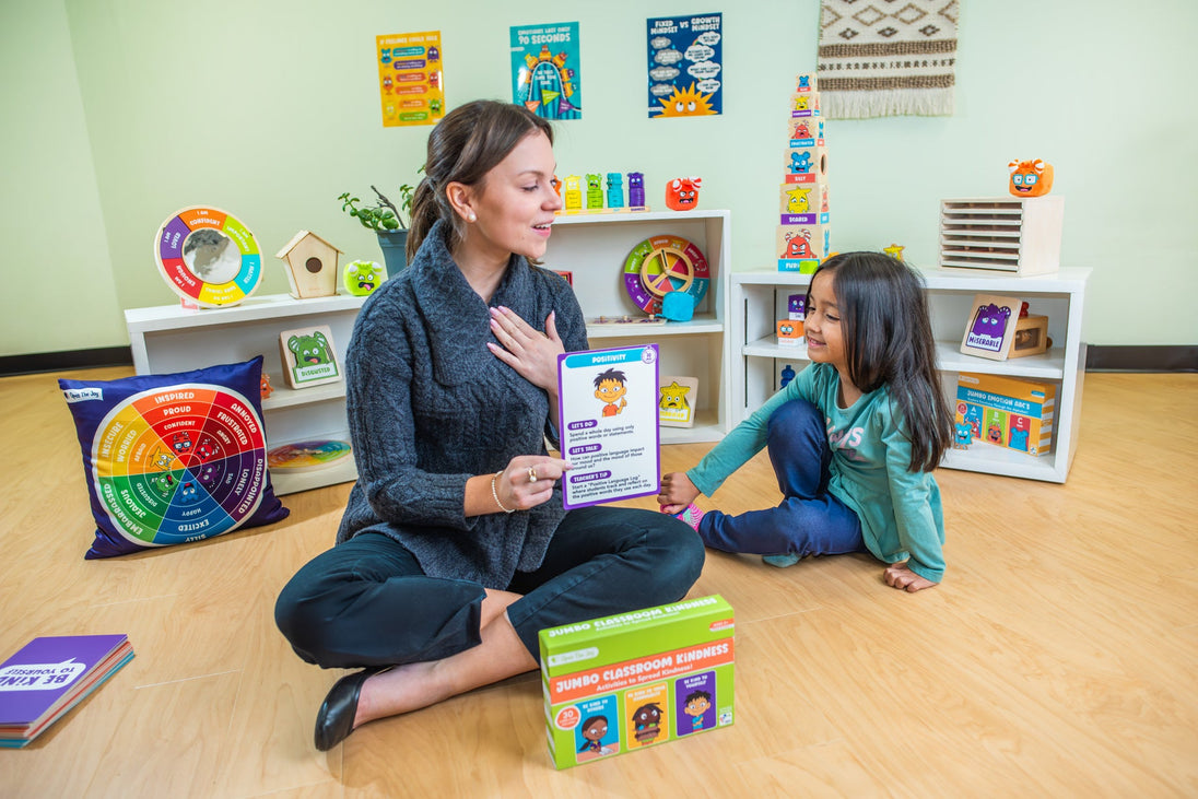 Teacher and children sitting together with the Jumbo Classroom Kindness Cards