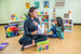 Teacher and children sitting together with the Jumbo Classroom Kindness Cards