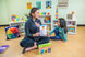 Teacher and children sitting together with the Jumbo Classroom Kindness Cards