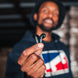 Man holding a Wicked Audio Mojo 500 earbud