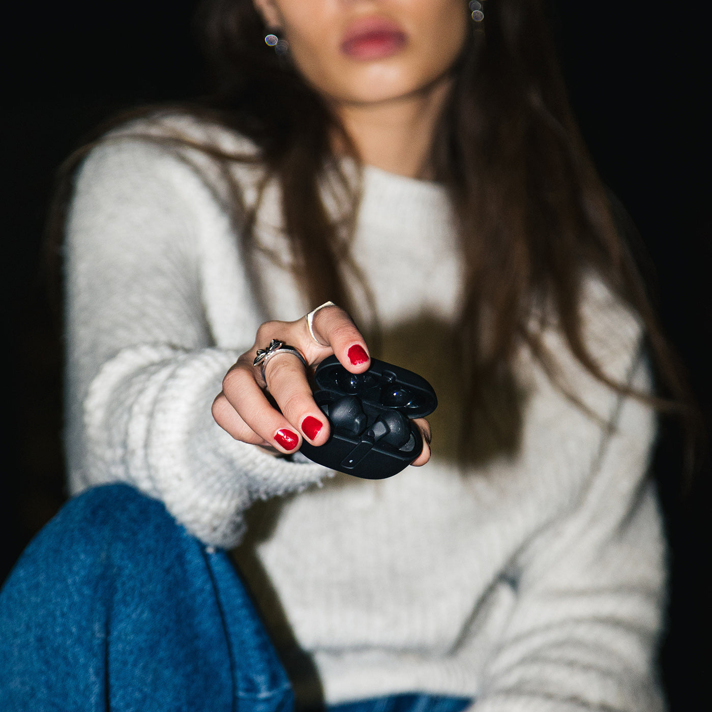 Woman holding the Wicked Audio Mojo 800 charging case