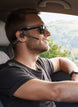 Man wearing OPN Sound Chat Pro headset while driving