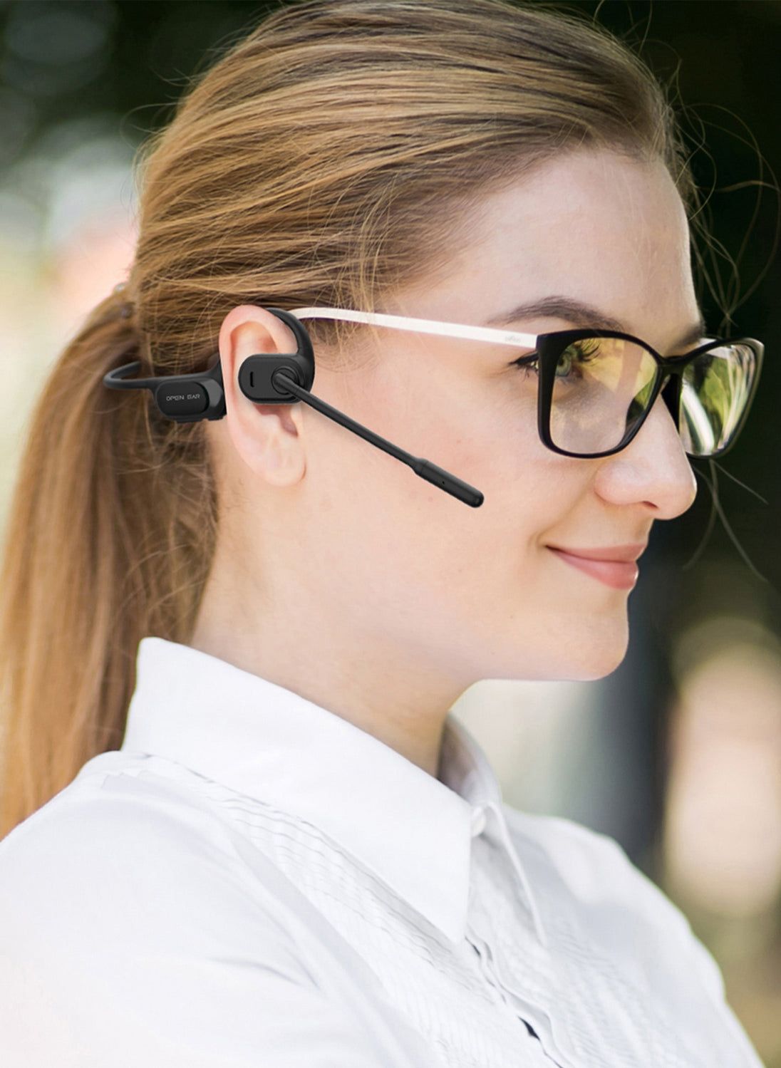 Woman wearing OPN Sound Chat Pro open-ear headset