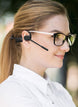 Woman wearing OPN Sound Chat Pro open-ear headset