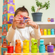 Child holding two emotion stacking rings up to their eyes