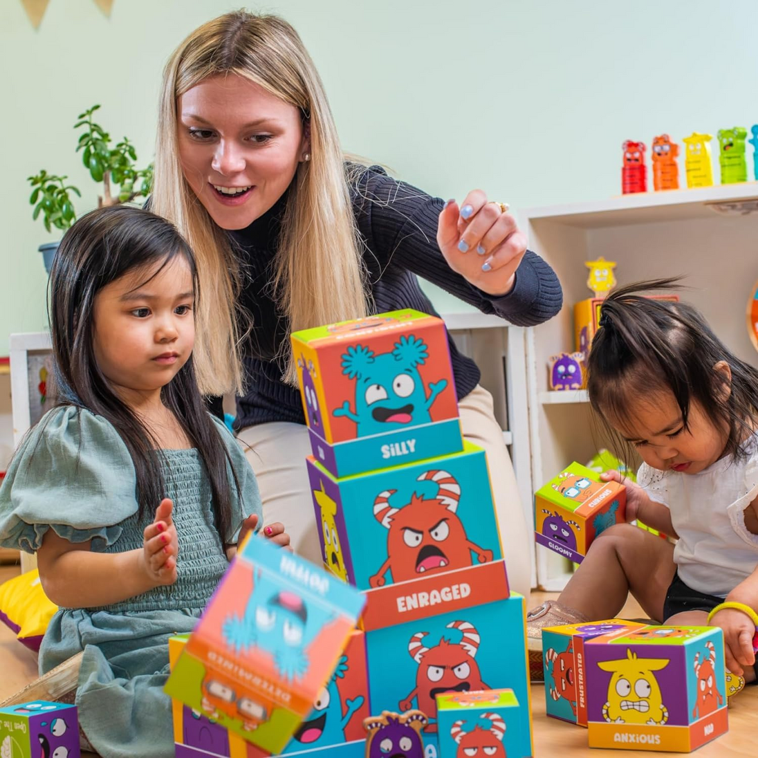 Adult and children building with the Tower of Emotions blocks