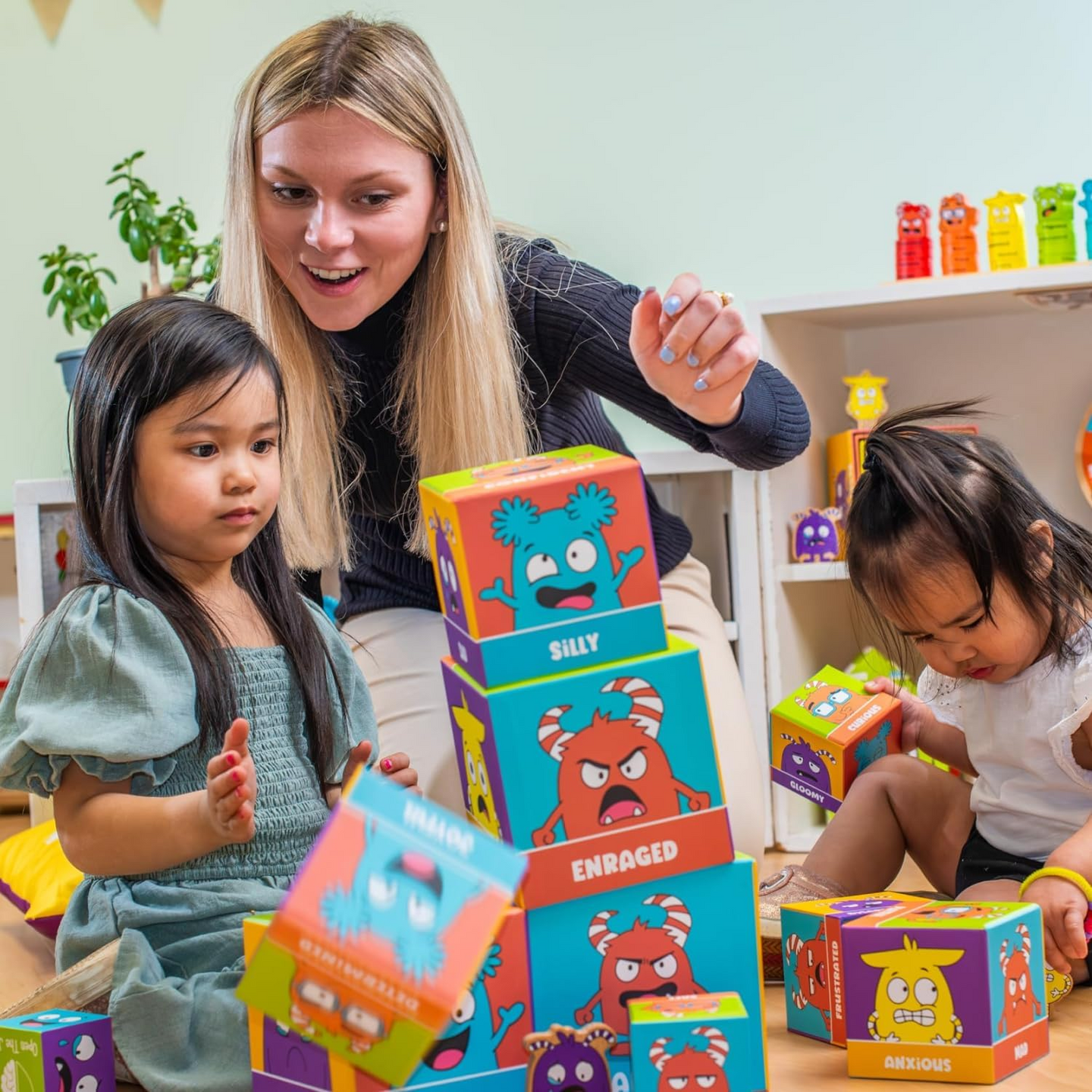 Adult and children building with the Tower of Emotions blocks