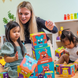 Adult and children building with the Tower of Emotions blocks