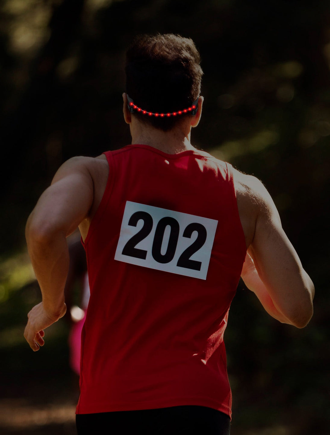 Race runner wearing OPN Sound Dashlyte+ headphones