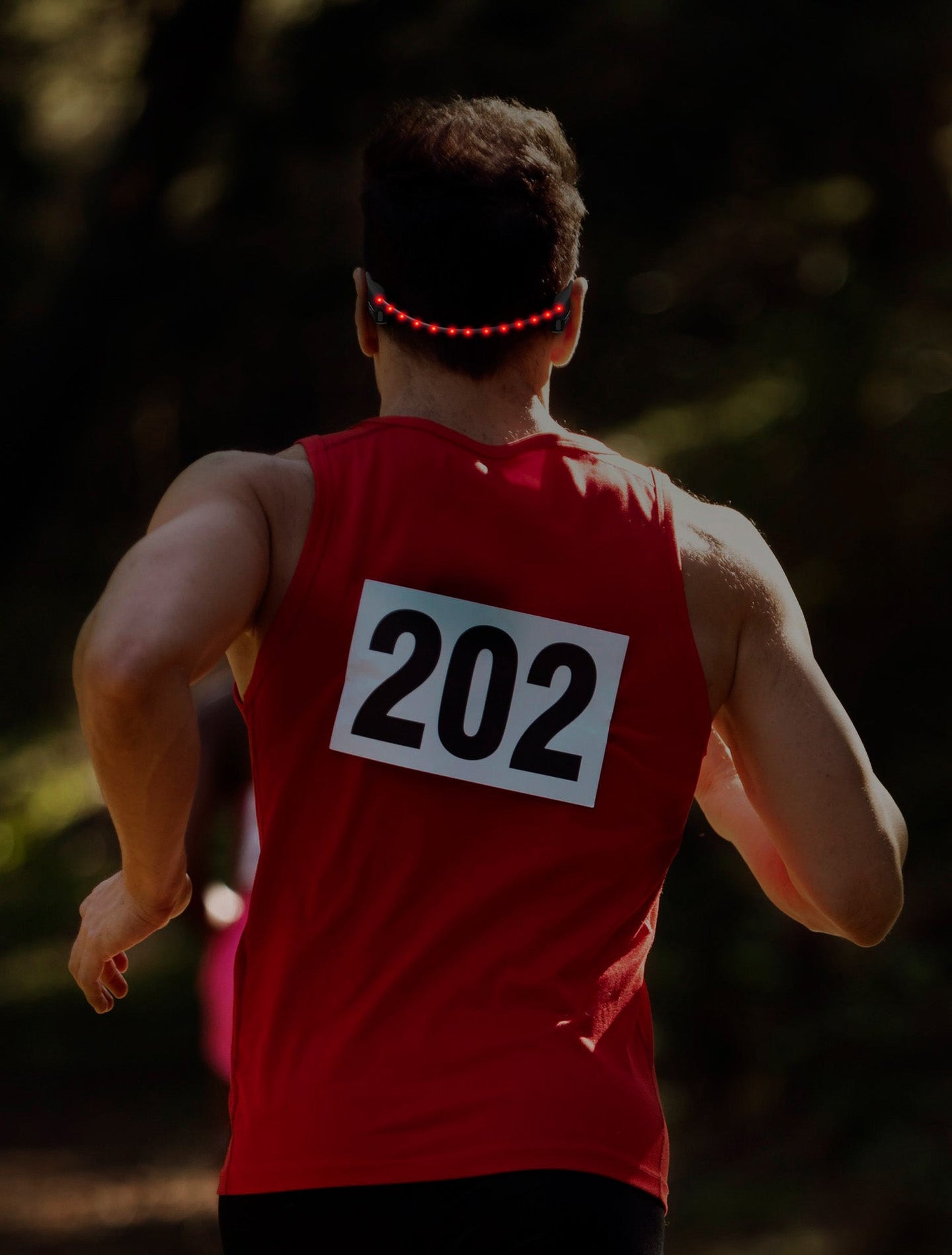Race runner wearing OPN Sound Dashlyte+ headphones