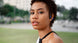 Woman training outdoors wearing sweat-proof OPN Sound Mezzo+ headphones